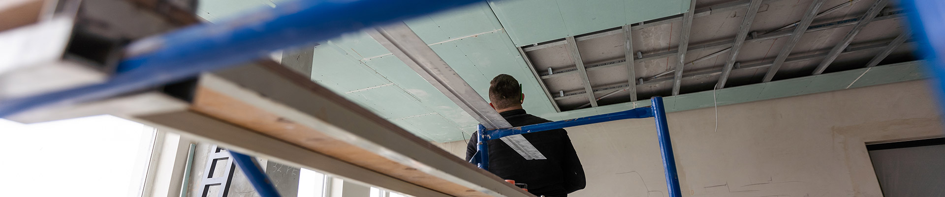 drywall-installers-men-holding-a-gypsum-board-fig-2023-04-22-03-45-51-utcWeb